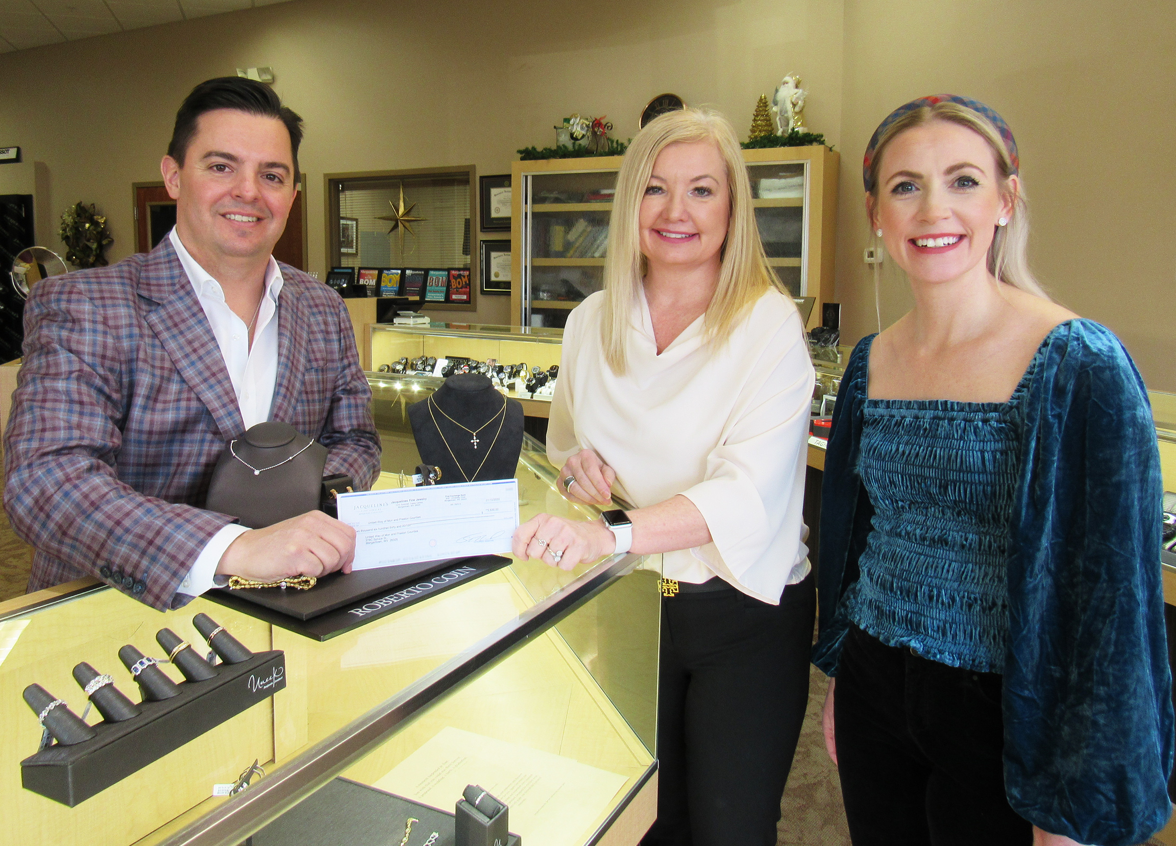 Jacqueline's Fine Jewelry owner Tom Licciardi presents a check to 2022 United Way Campaign Chair Tammie Alexander and United Way Director of Development Macall Speaker.